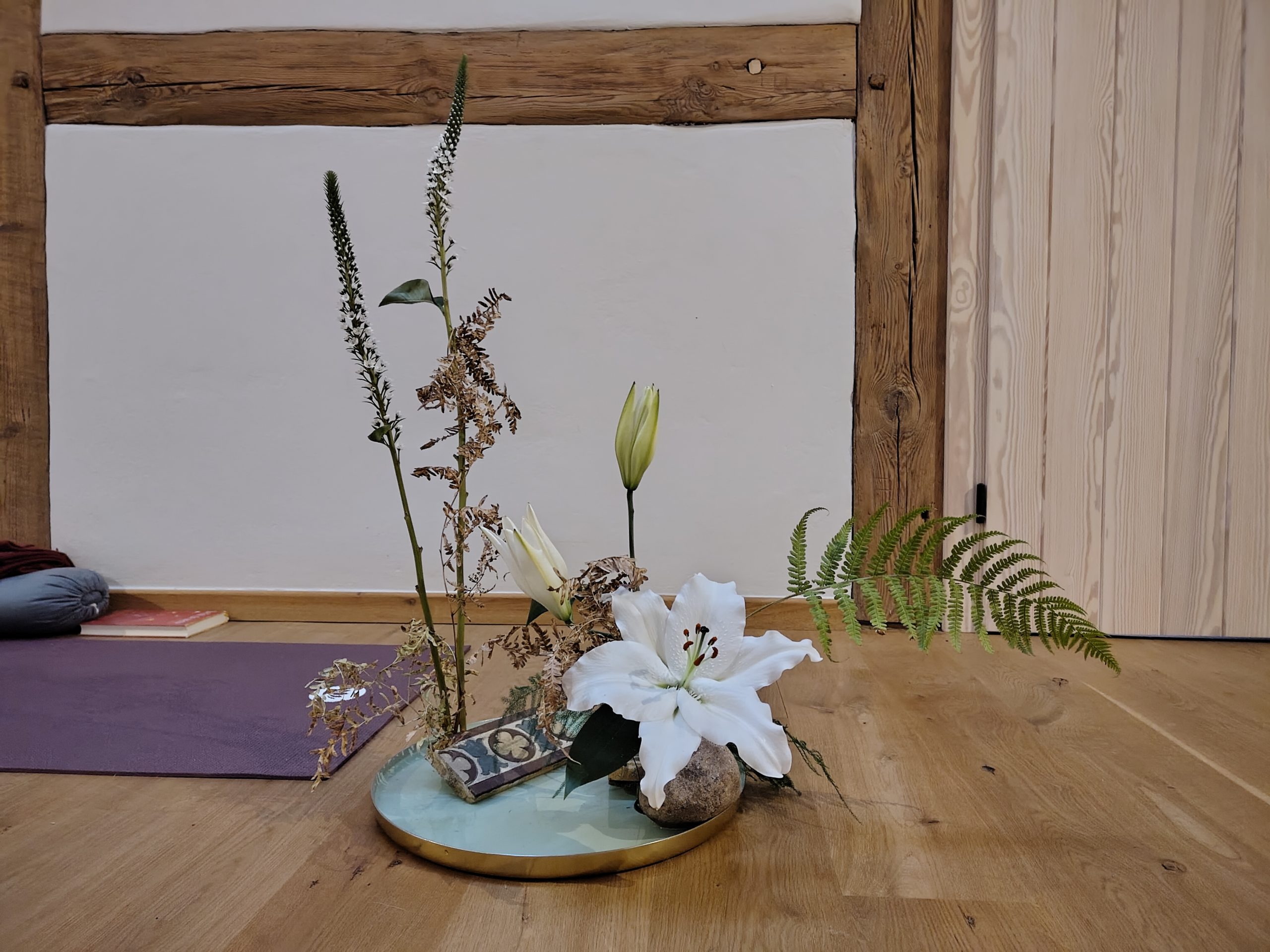 Ikebana zu Wandel und Vergänglichkeit Ikebana mit verwelkten und blühenden Pflanzen als Symbol für Wandel, Vergänglichkeit und Loslassen im Schweigeretreat